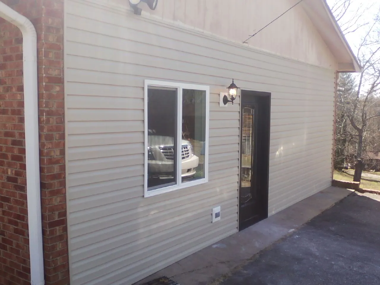 New vinyl siding and entry door on a room addition in Ruby